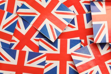 Small paper flags of United Kingdom as background, top view