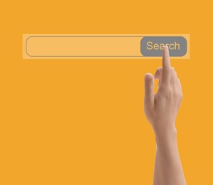 Image of Man using search bar on virtual screen against orange background, closeup