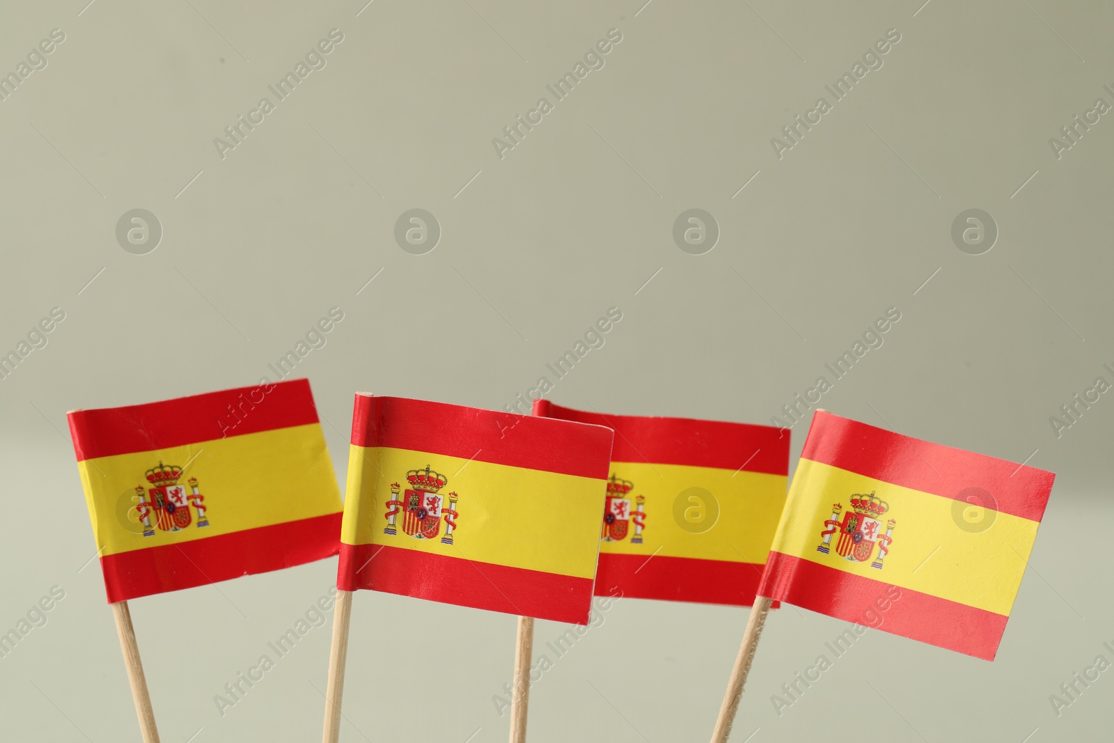 Photo of Small paper flags of Spain on light background