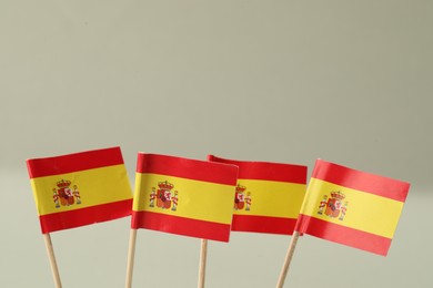 Small paper flags of Spain on light background