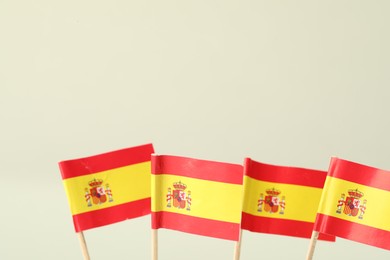 Photo of Small paper flags of Spain on light background