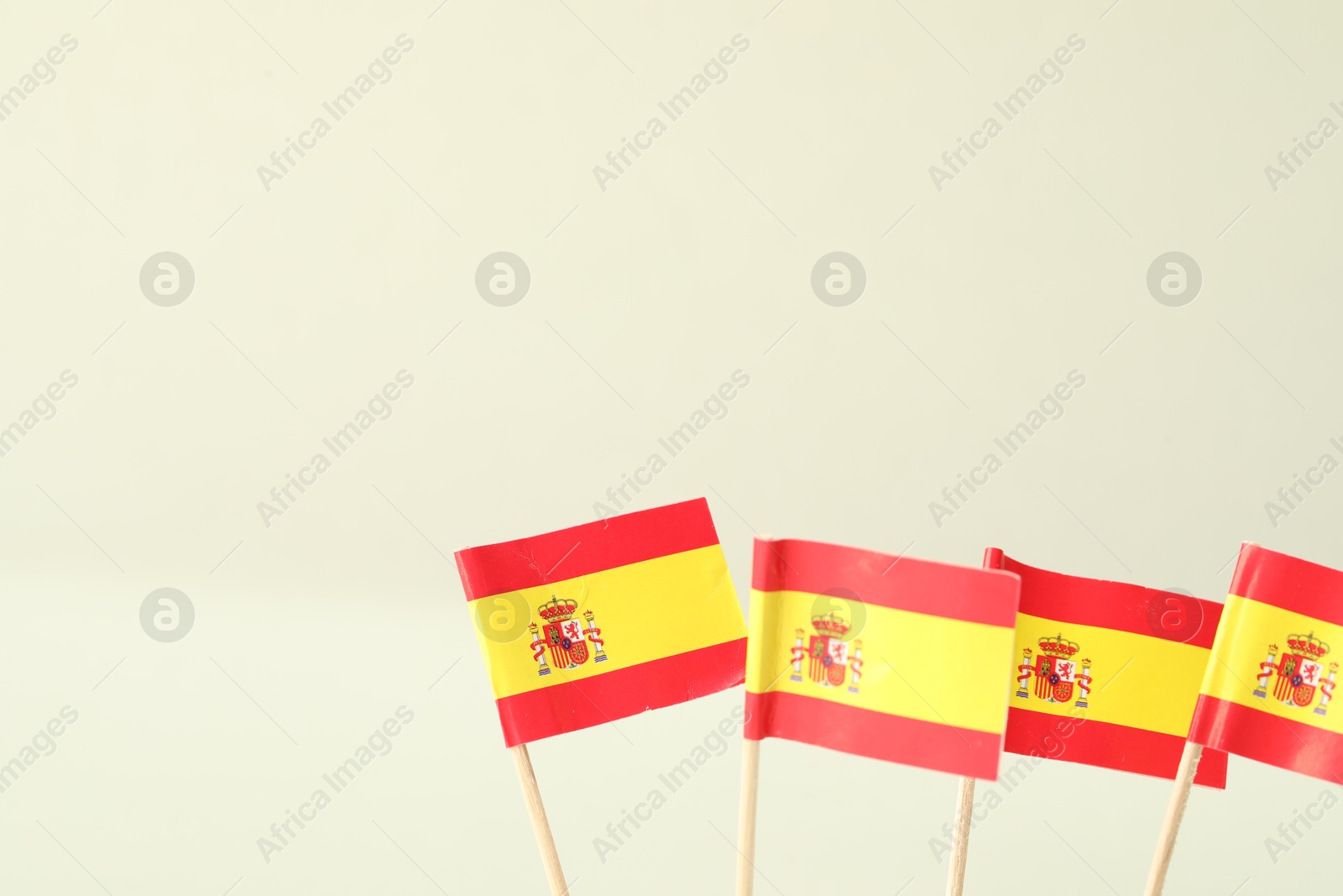 Photo of Small paper flags of Spain on light background