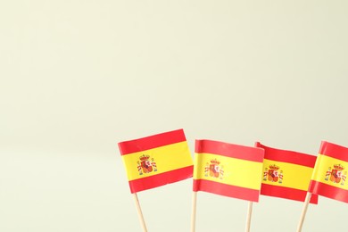 Photo of Small paper flags of Spain on light background