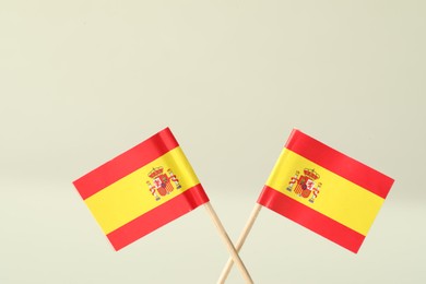 Small paper flags of Spain on light background