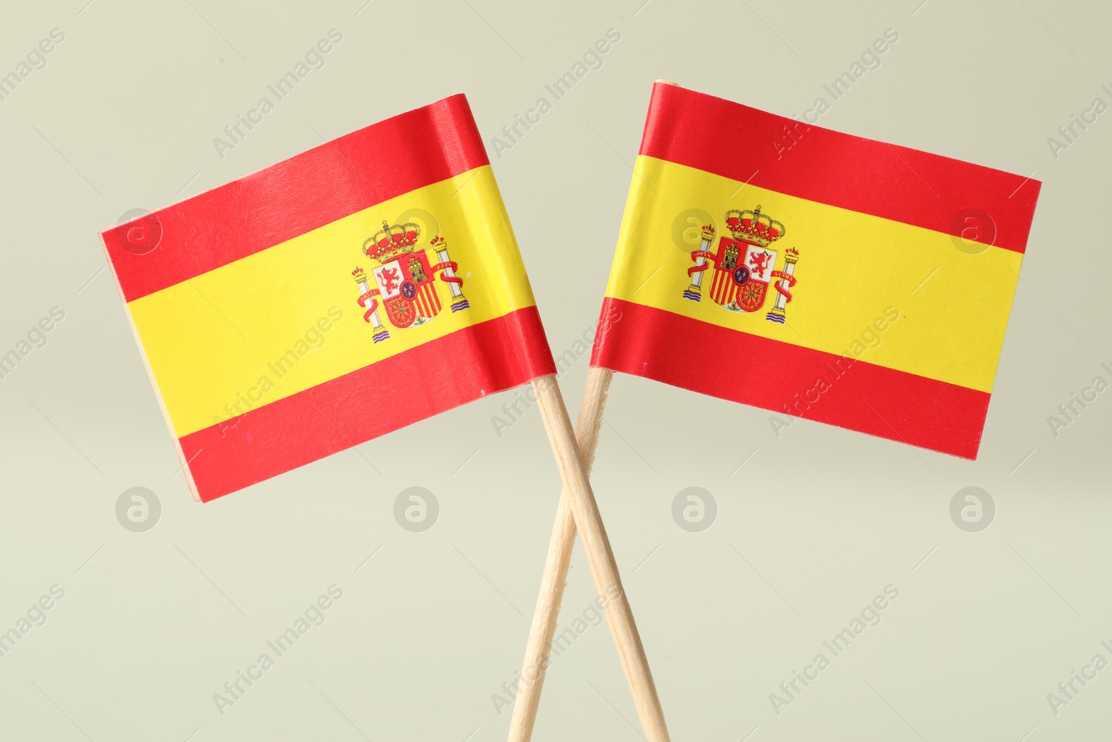 Photo of Small paper flags of Spain on light background