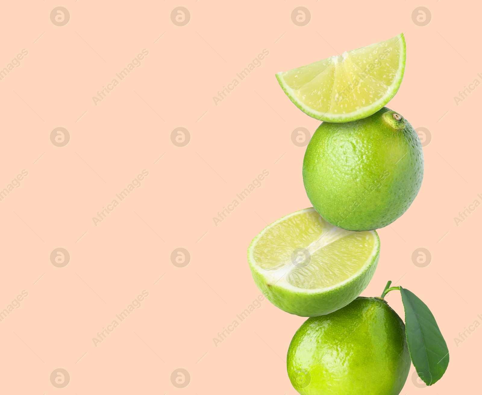 Image of Stacked fresh limes on pink background, space for text