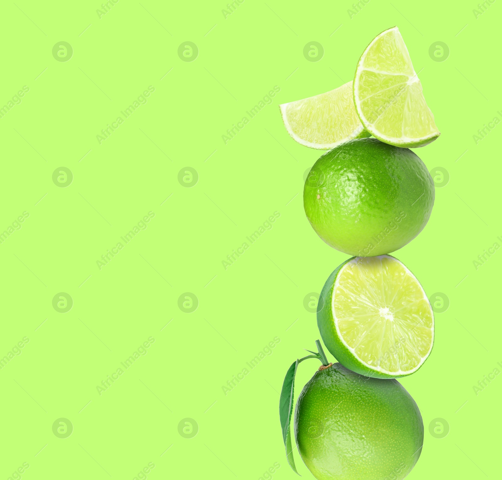 Image of Stacked fresh limes on light green background, space for text