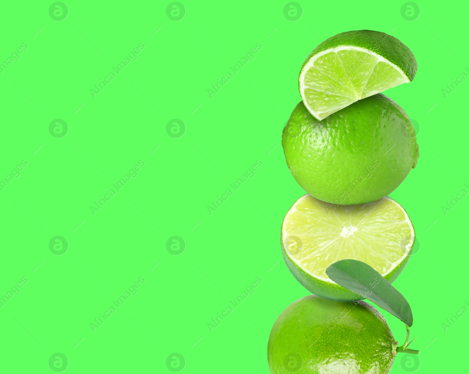 Image of Stacked fresh limes on green background, space for text