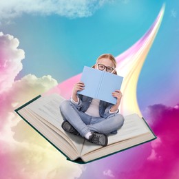 Image of Back to school. Girl reading while flying on book in sky