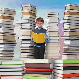 Happy schoolboy among stacks of books in sky. Back to school