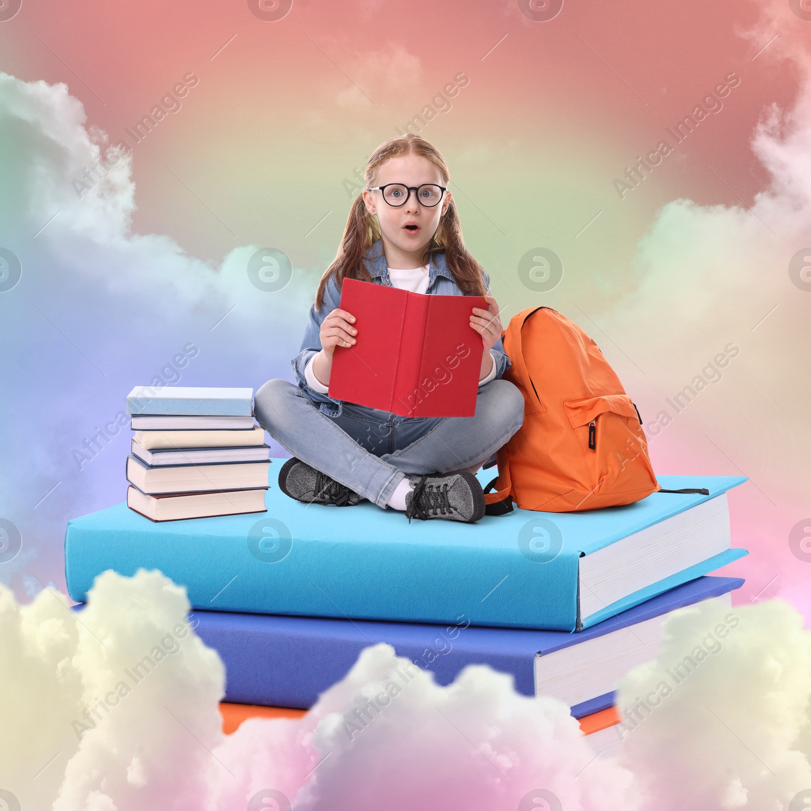 Image of Back to school. Surprised girl reading on stack of book in sky