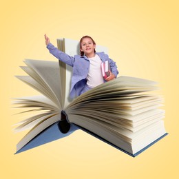 Image of Back to school. Happy girl coming out of book on yellow background