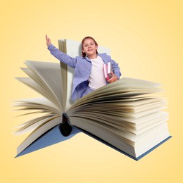 Back to school. Happy girl coming out of book on yellow background