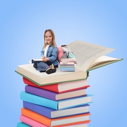 Image of Back to school. Happy girl reading on stack of book against light blue background
