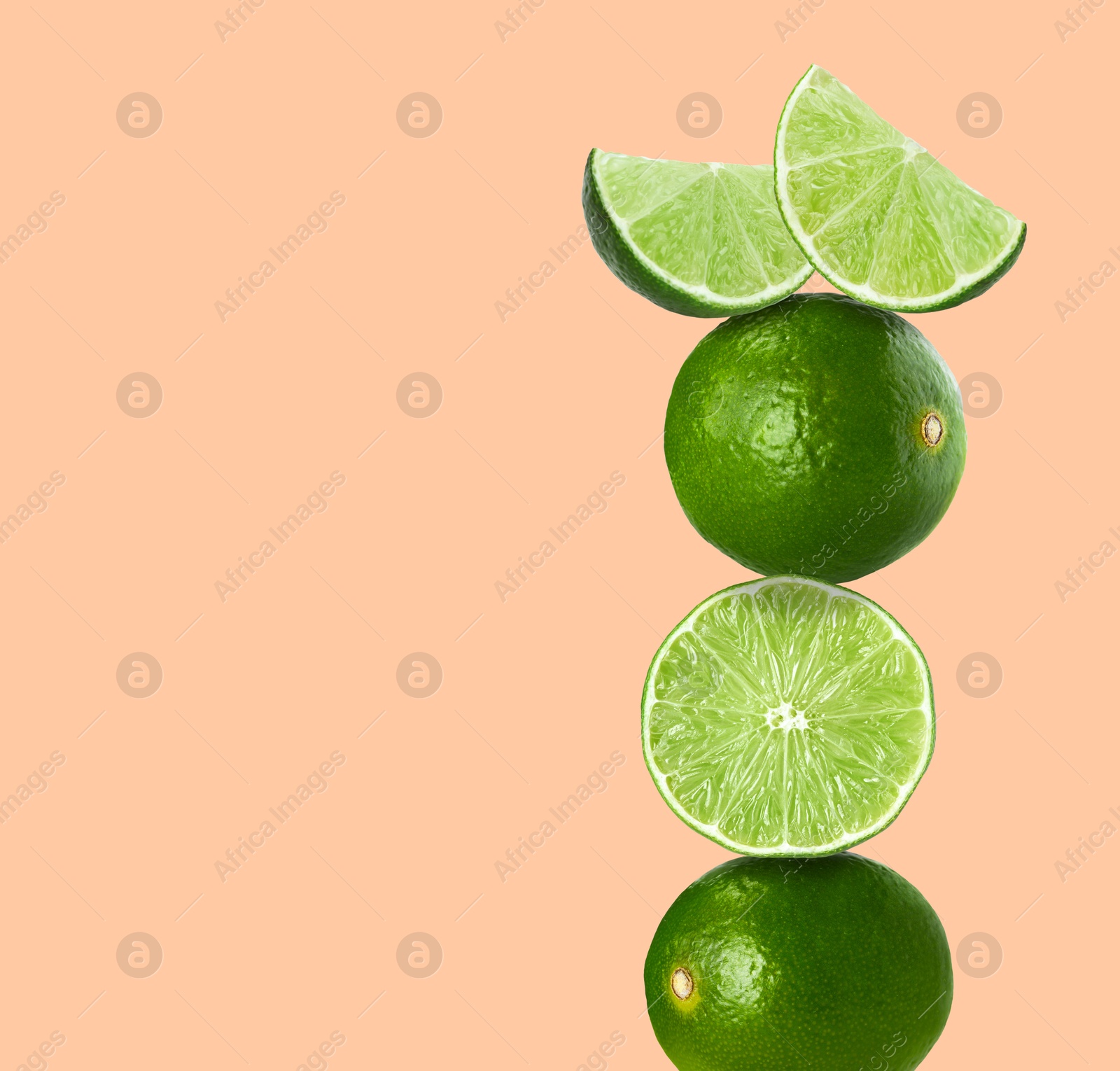 Image of Stacked fresh limes on pink background, space for text