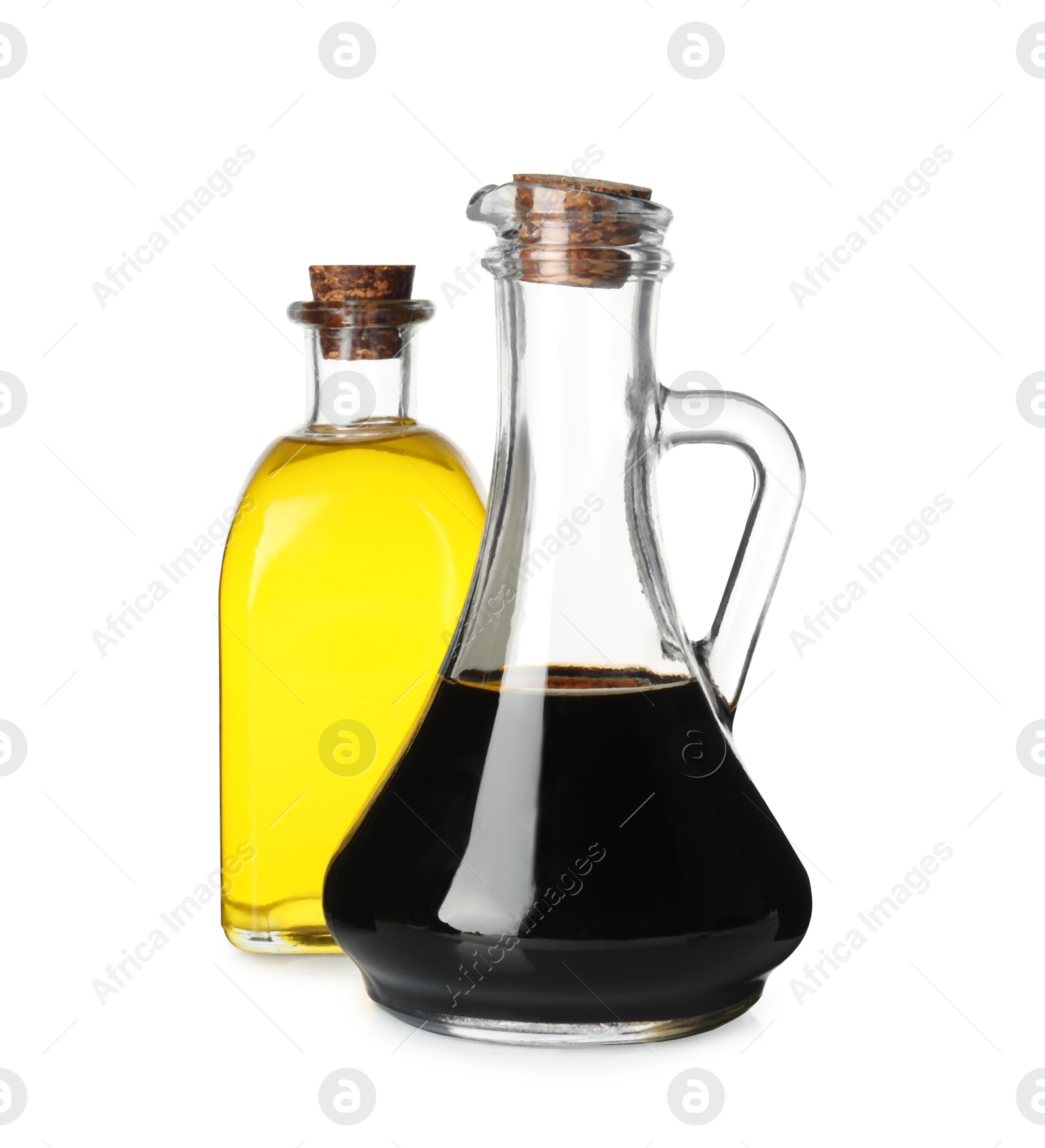 Photo of Balsamic vinegar in glass jug and oil isolated on white