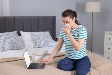 Photo of Sick woman having online consultation with doctor via laptop at home