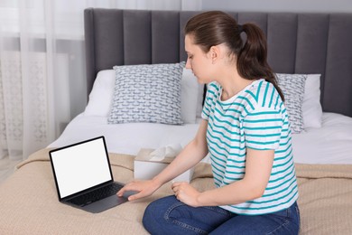 Sick woman having online consultation with doctor via laptop at home