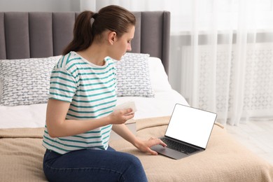 Photo of Sick woman having online consultation with doctor via laptop at home