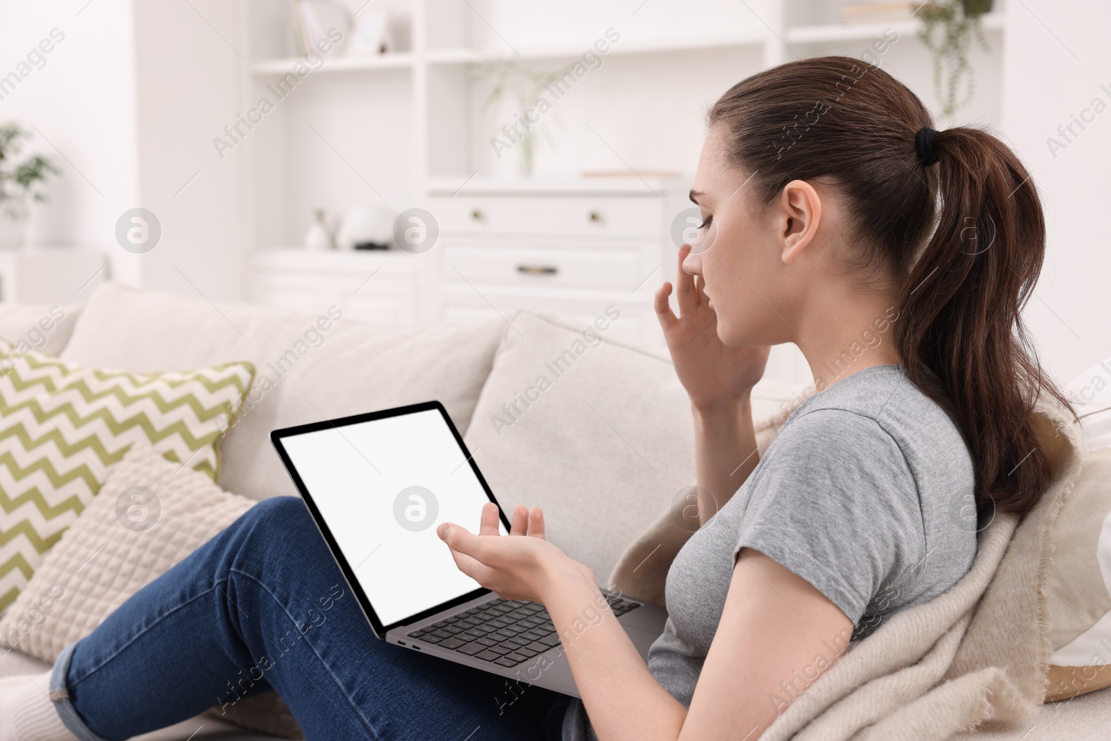 Photo of Sick woman having online consultation with doctor via laptop at home