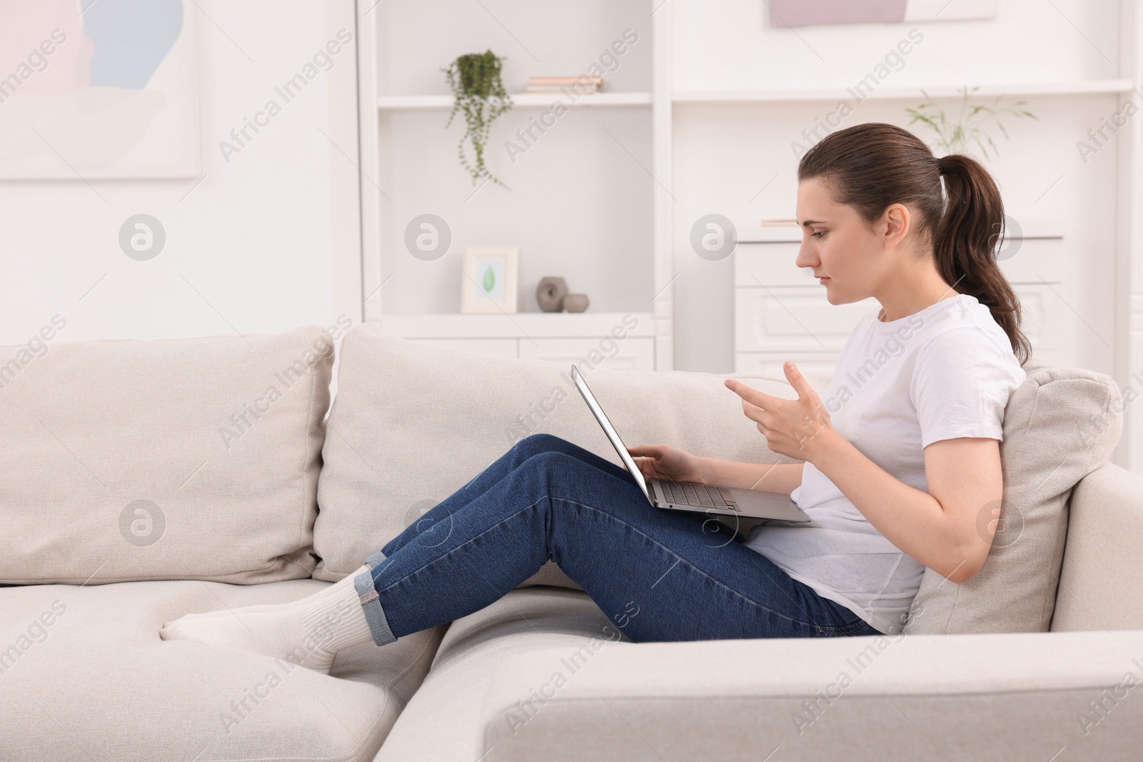 Photo of Sick woman having online consultation with doctor via laptop at home