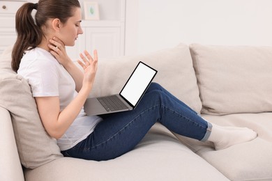 Photo of Sick woman having online consultation with doctor via laptop at home