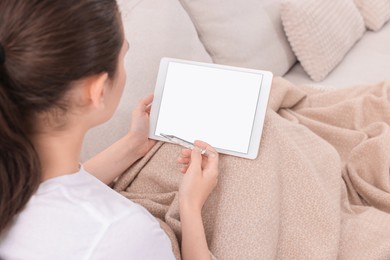 Photo of Sick woman with thermometer having online consultation with doctor via tablet at home