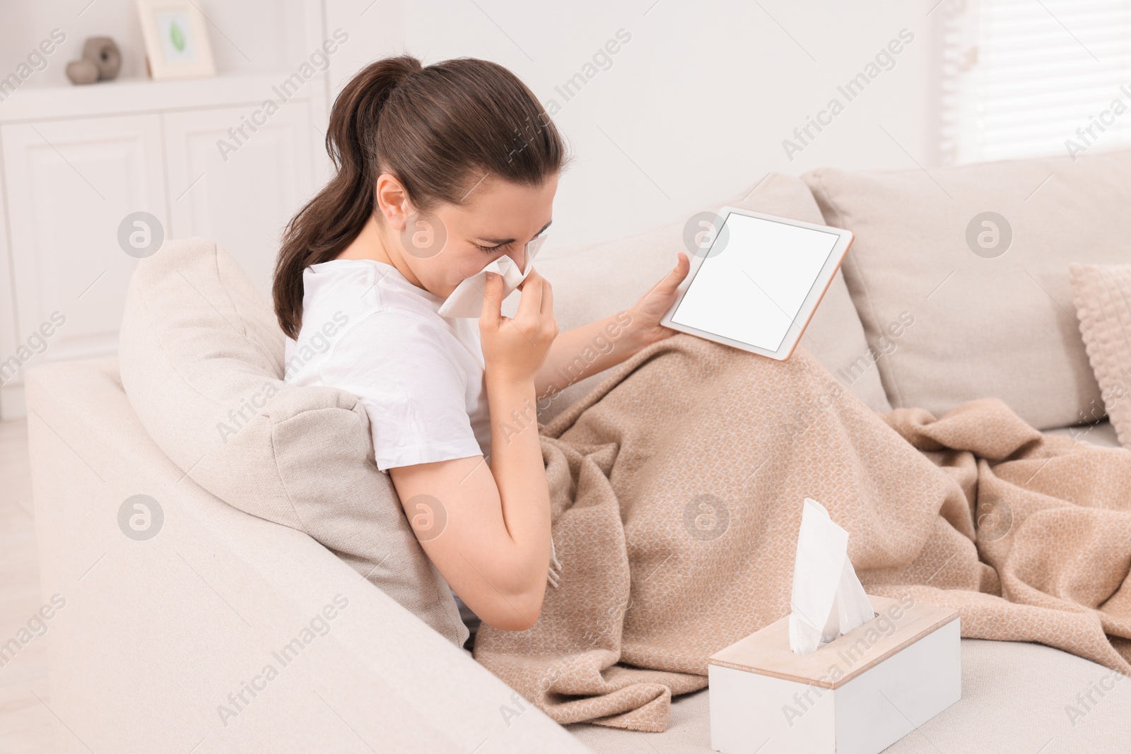 Photo of Sick woman having online consultation with doctor via tablet at home