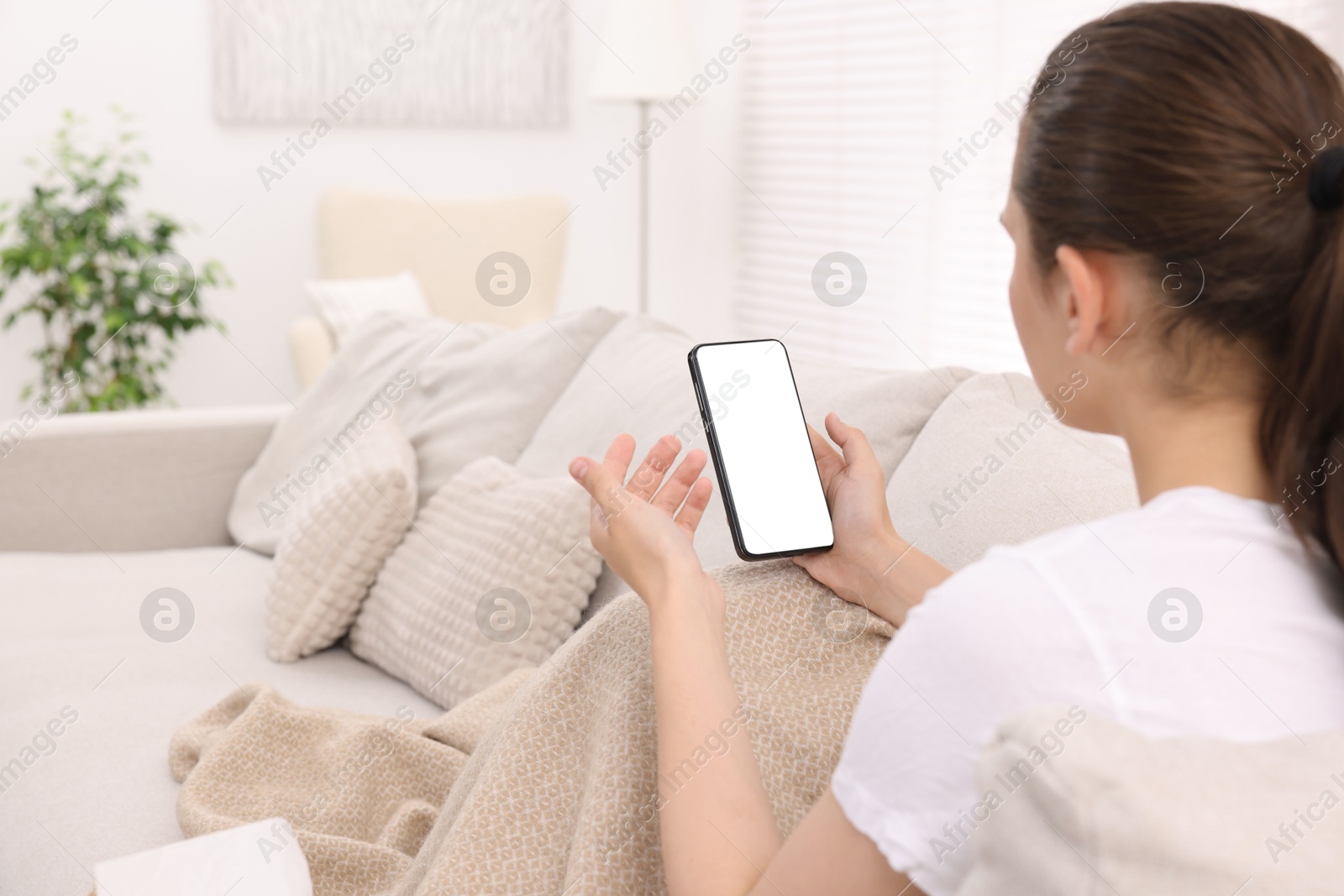 Photo of Sick woman having online consultation with doctor via smartphone at home