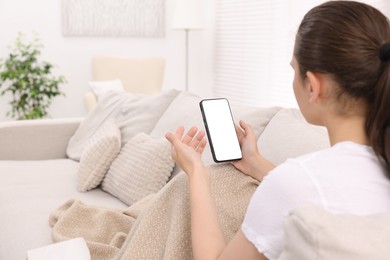 Photo of Sick woman having online consultation with doctor via smartphone at home