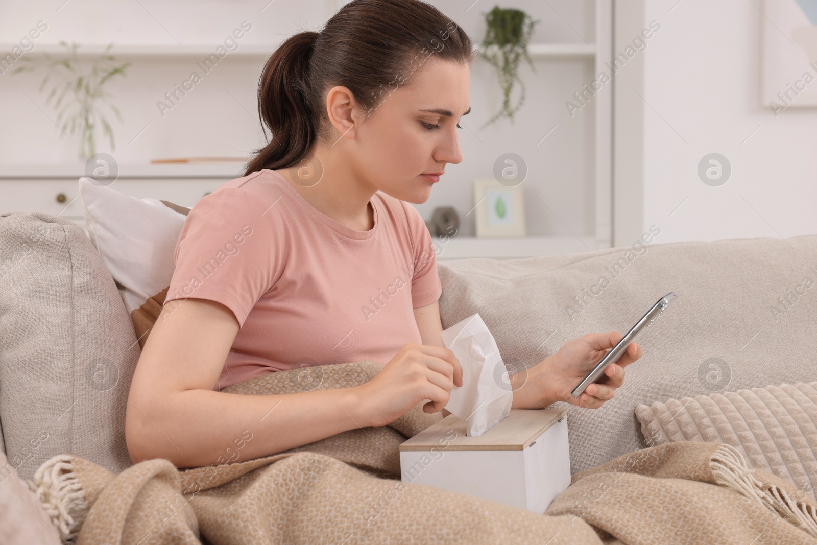 Photo of Sick woman having online consultation with doctor via smartphone at home