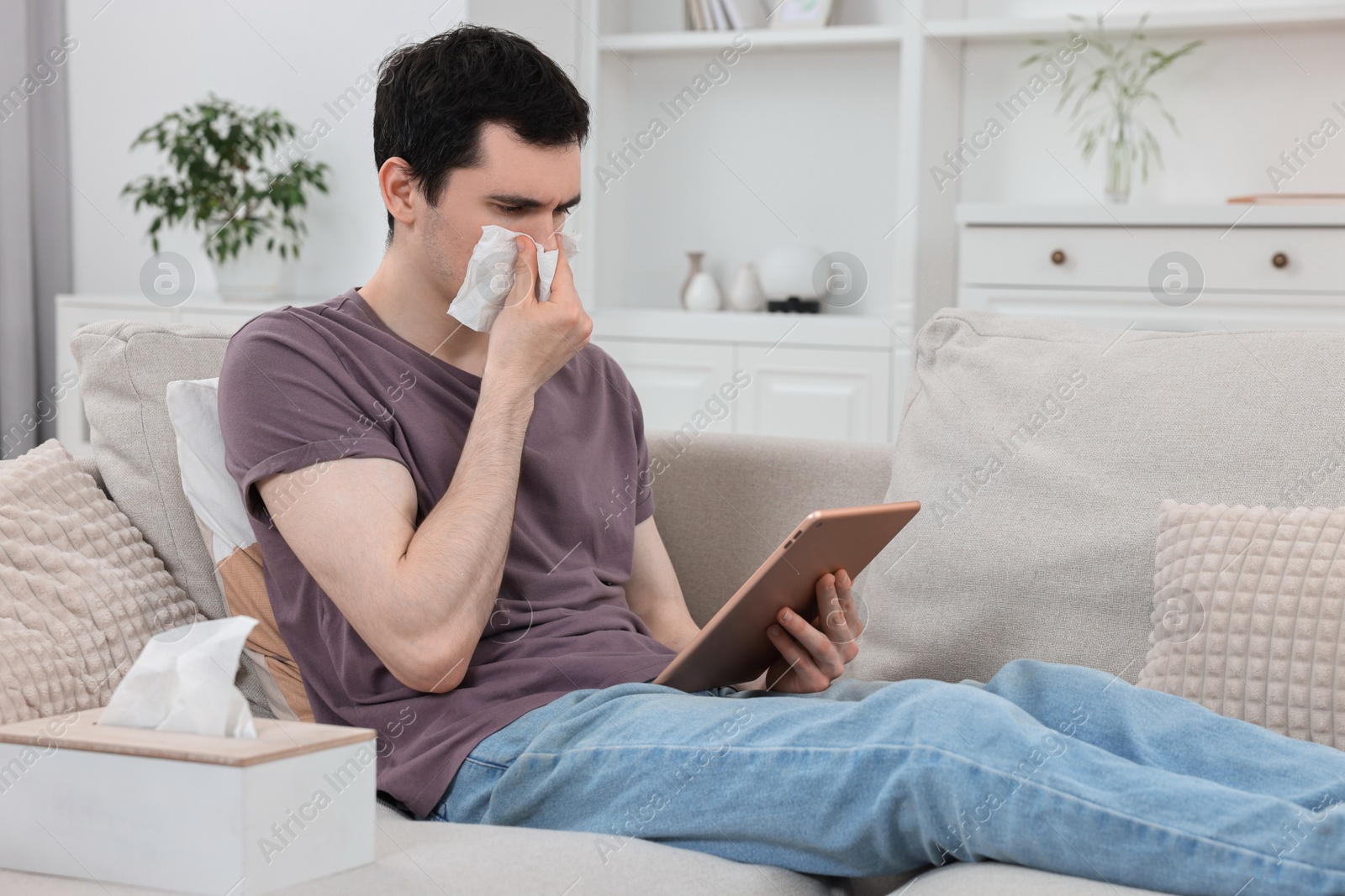 Photo of Sick man having online consultation with doctor via tablet at home