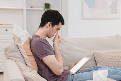 Photo of Sick man having online consultation with doctor via tablet at home