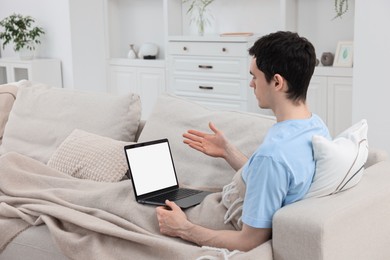 Photo of Sick man having online consultation with doctor via laptop at home