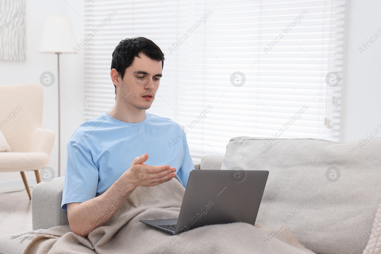 Photo of Sick man having online consultation with doctor via laptop at home