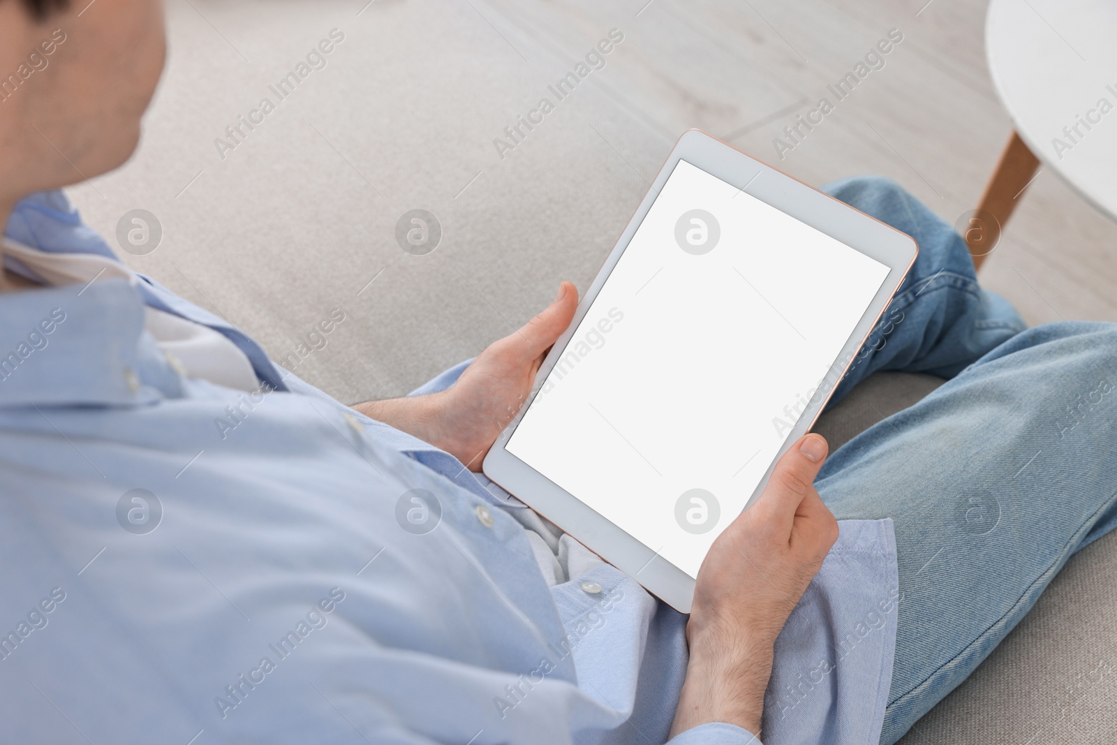 Photo of Sick man having online consultation with doctor via tablet at home, closeup