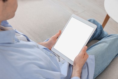 Sick man having online consultation with doctor via tablet at home, closeup