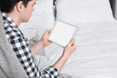 Photo of Sick man having online consultation with doctor via tablet at home