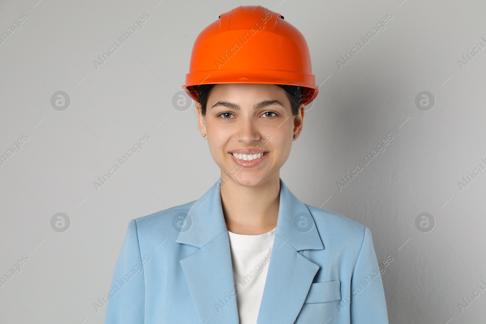 Photo of Engineer in hard hat on grey background