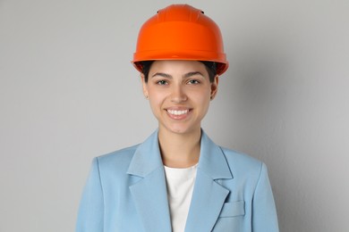 Photo of Engineer in hard hat on grey background