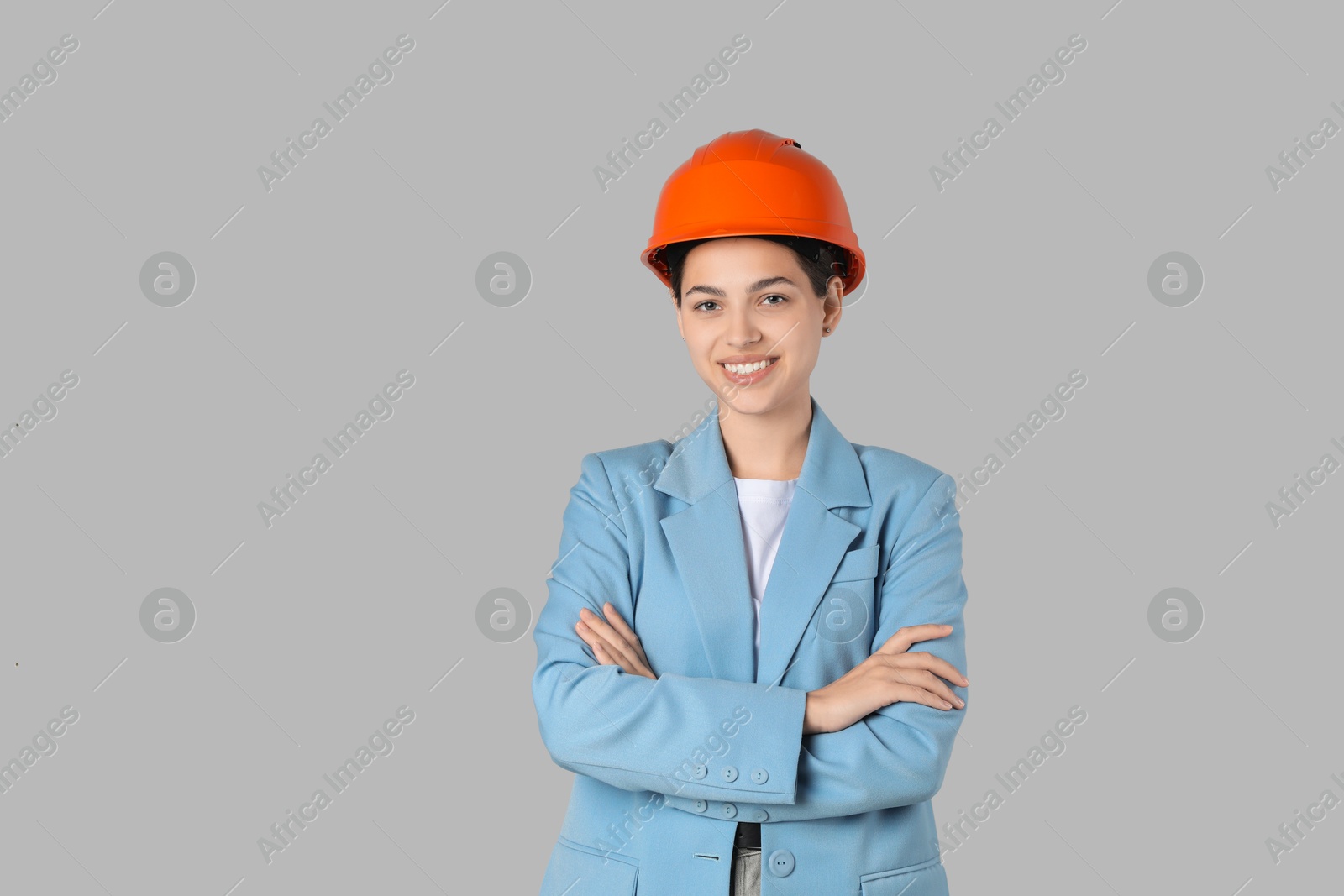 Photo of Engineer in hard hat on grey background