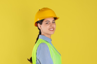 Engineer in hard hat on yellow background