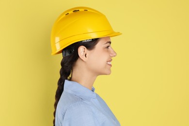 Engineer in hard hat on yellow background