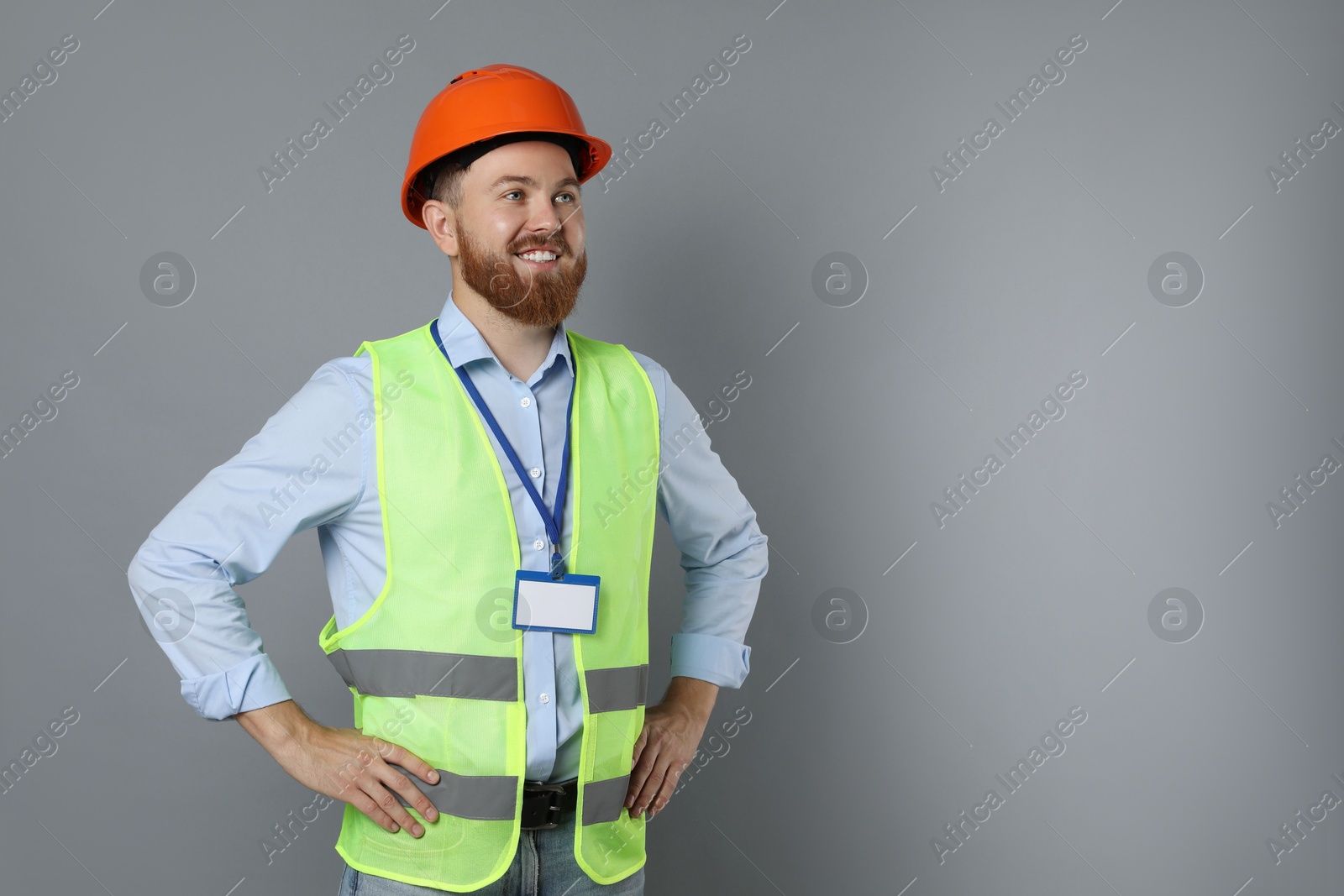 Photo of Engineer in hard hat on grey background, space for text