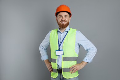 Photo of Engineer in hard hat on grey background