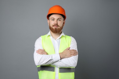 Engineer in hard hat on grey background