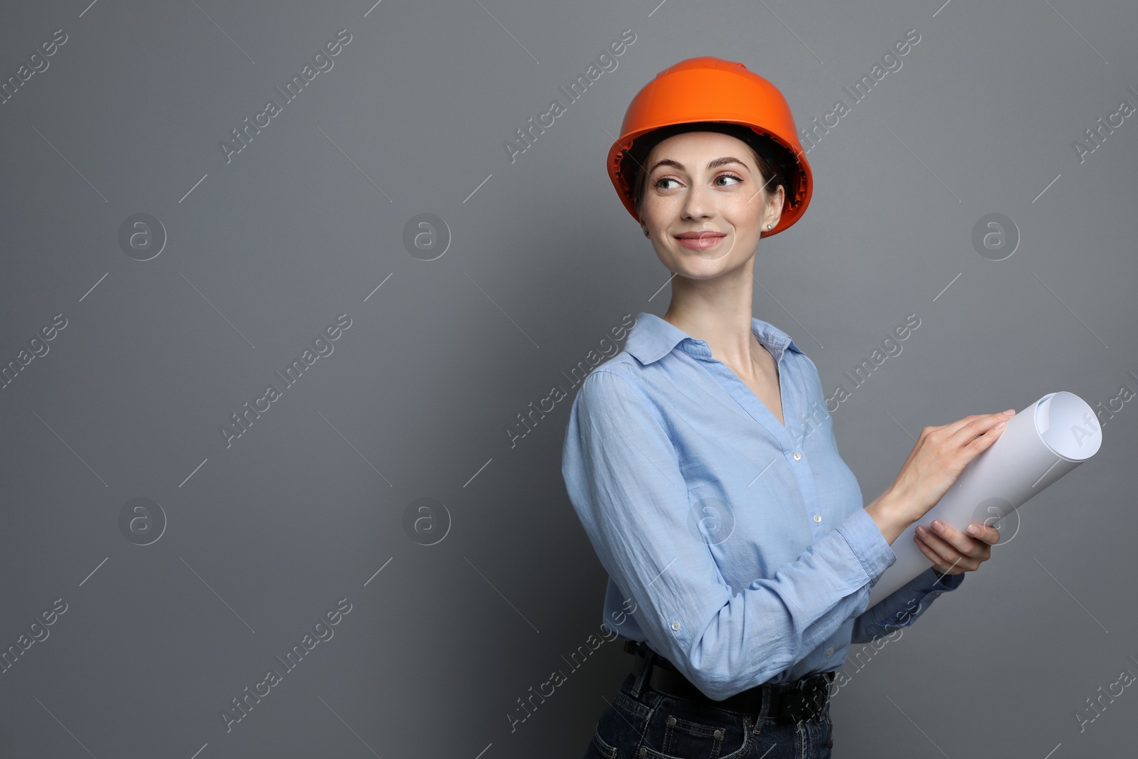 Photo of Engineer in hard hat with draft on grey background, space for text