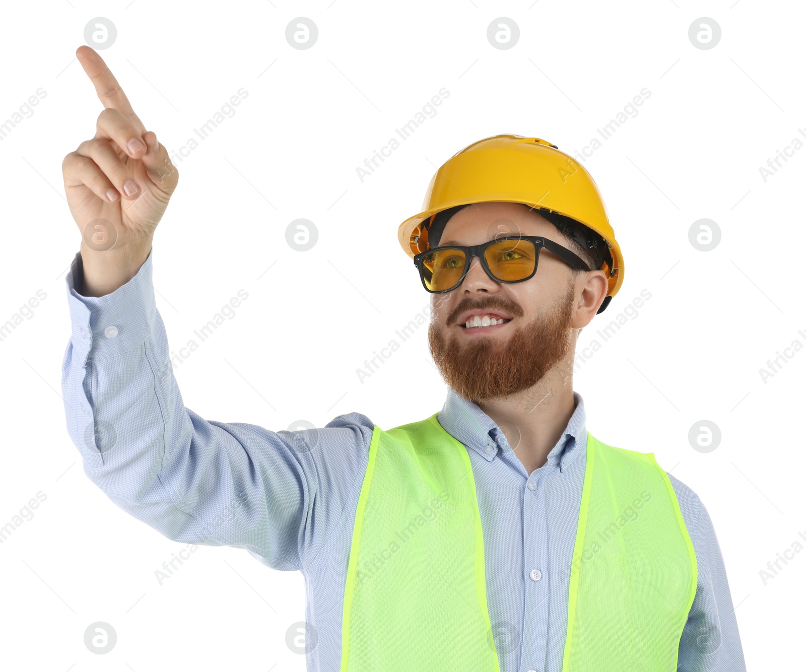 Photo of Engineer in hard hat and protective glasses pointing at something on white background