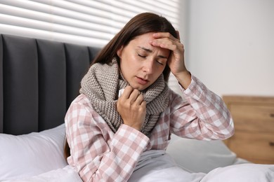 Photo of Sick woman with tissue in bed. Cold symptoms