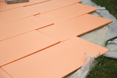 Photo of Under pool foam tiles on green grass in backyard